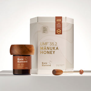 UMF 35.2 Manuka Honey jar with wooden lid and packaging on a white background