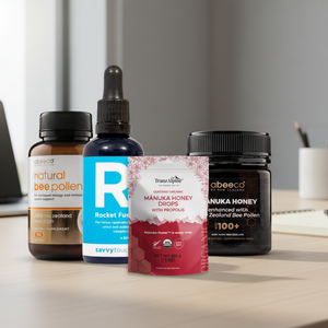 Collection of health and wellness products including bee pollen, honey, and supplements on a office desk