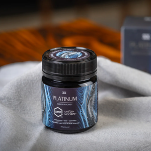 Platinum Manuka Honey jar with UMF and MGO certification on a textured surface