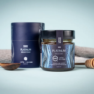 25+ UMF Platinum Manuka Honey jar and packaging on a light blue background