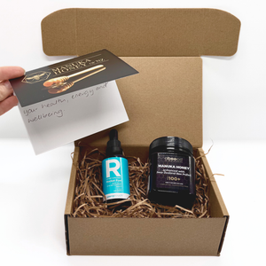 Manuka honey and Rocket Fuel in a cardboard box with a card on a white background