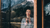 lady standing at a window looking out at a snowy mountain