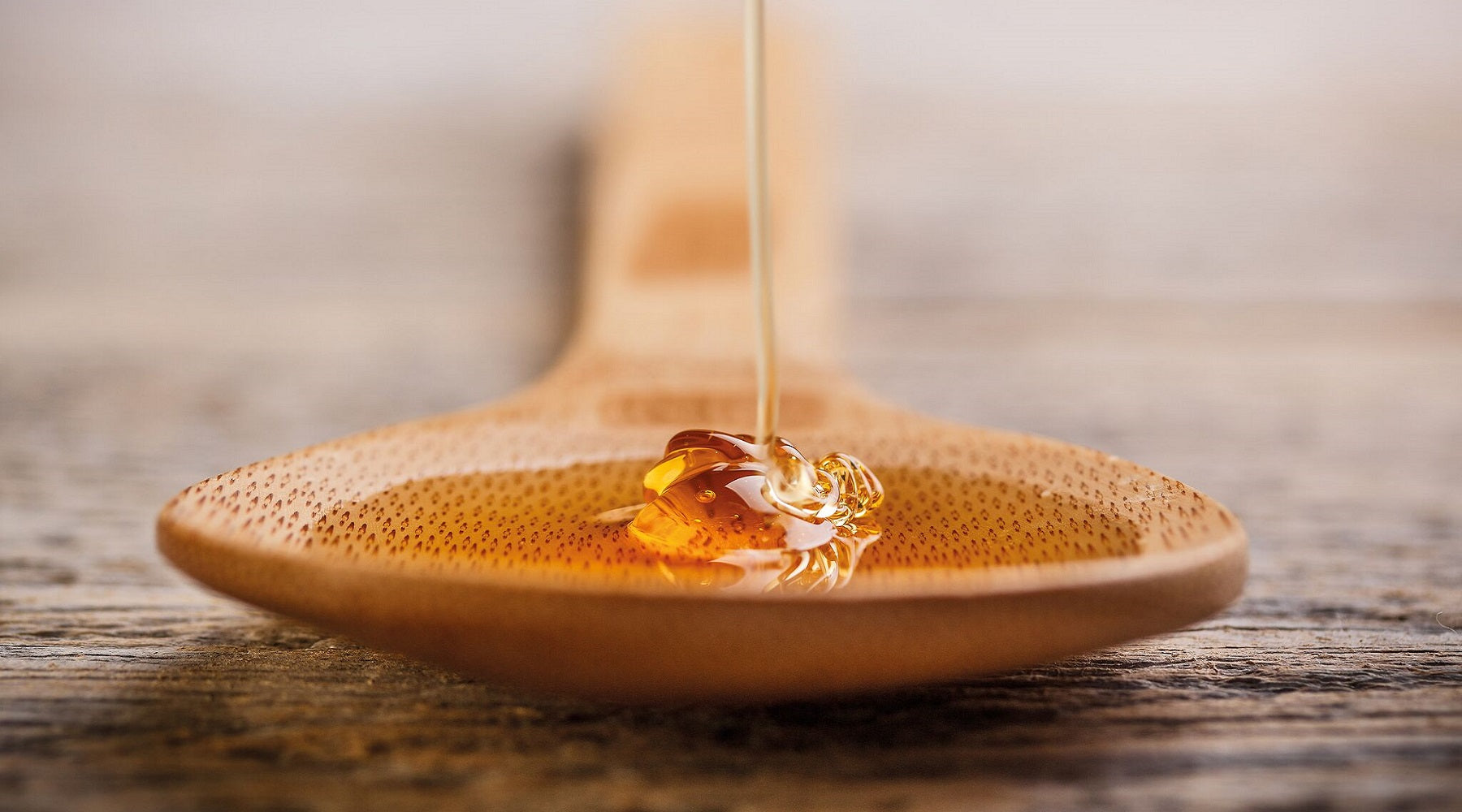 Special Manuka Honey Dripping onto a Wooden Spoon