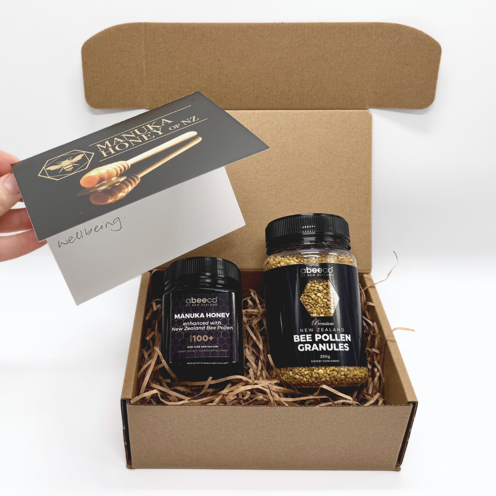 Box containing Manuka Honey and Bee Pollen Granules with a card on a white background