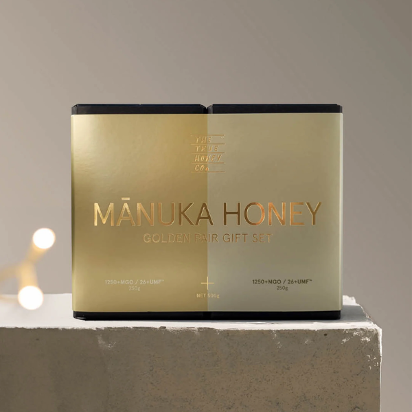 Manuka Honey Golden Pair Gift Set on a gray surface with a neutral background