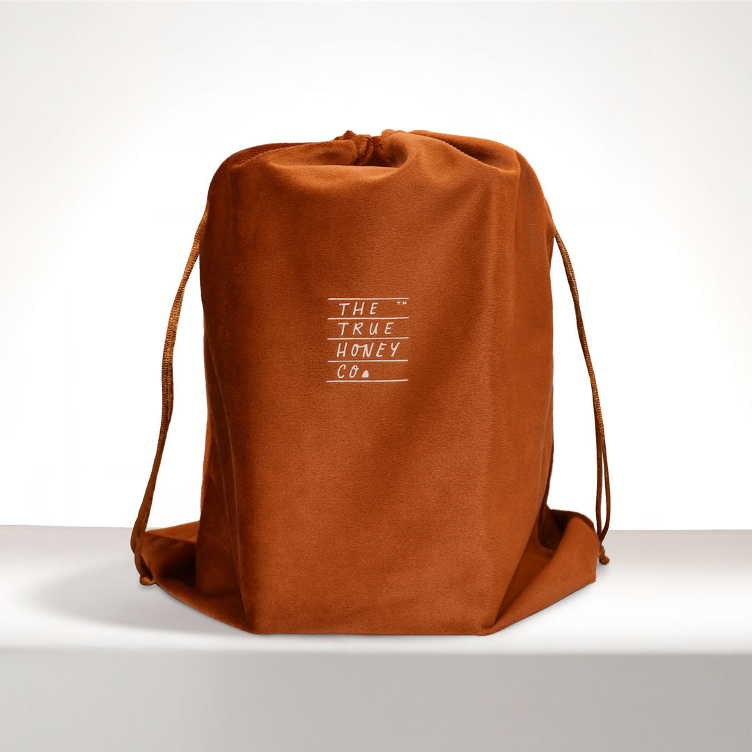 Brown drawstring bag with 'The True Honey Co.' logo on a white background