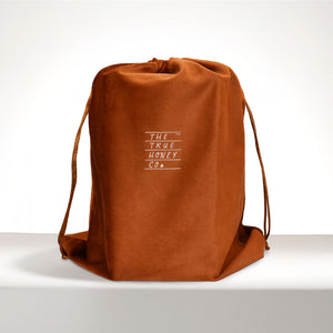 Brown drawstring bag with 'The True Honey Co.' logo on a white background