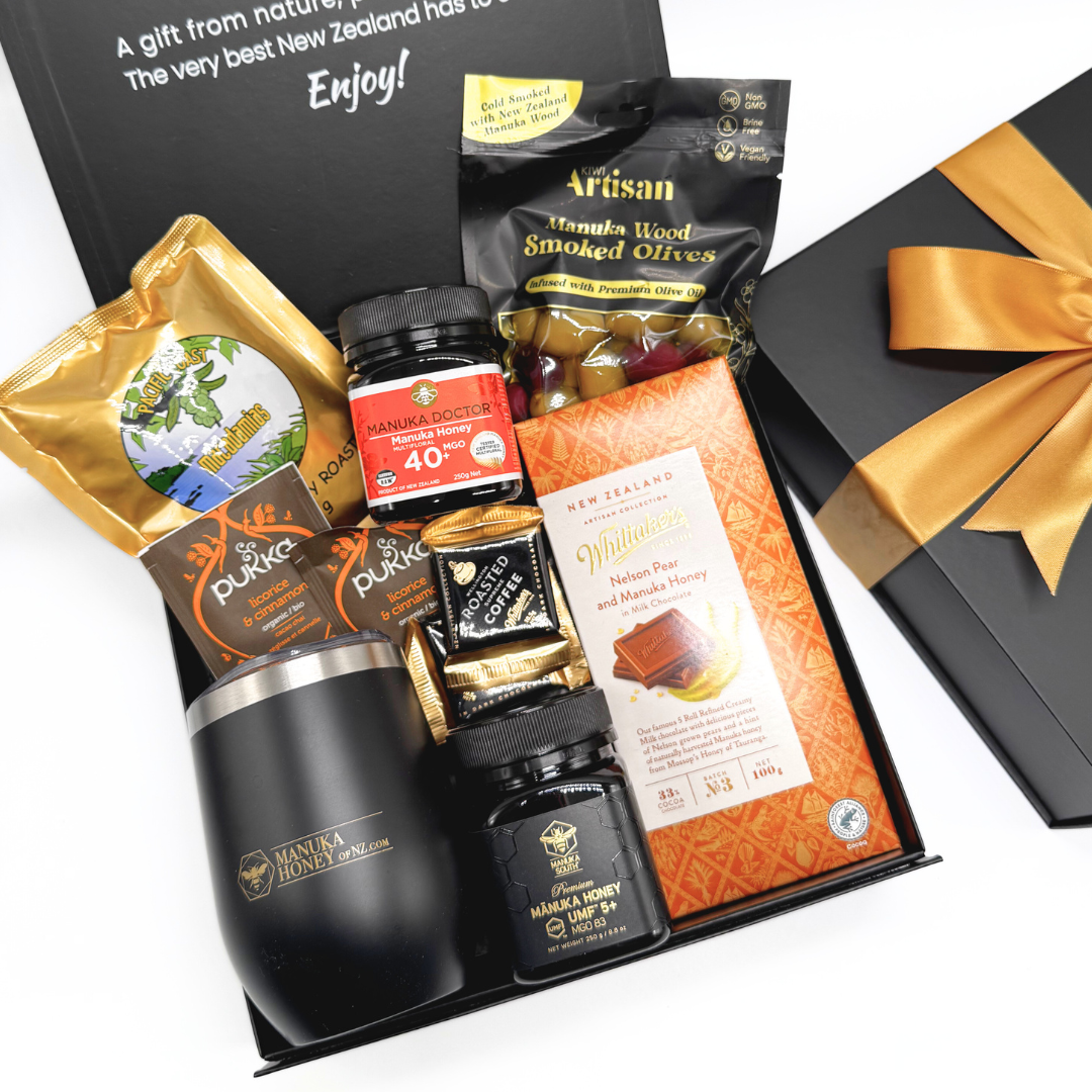Gift set with Manuka honey, olives, and other New Zealand products in a black box.