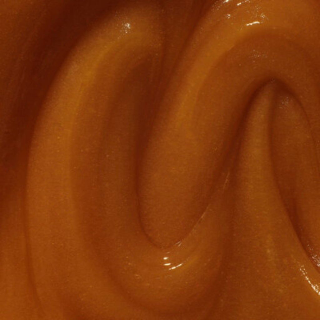 Close-up of a swirl of brown caramel sauce Manuka Health MGO1000+