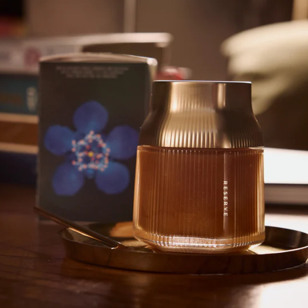 Brown textured Manuka Honey Jar 'Reserve' on a wooden surface with a blurred background