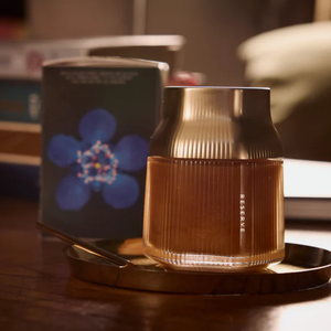 Brown textured Manuka Honey Jar 'Reserve' on a wooden surface with a blurred background