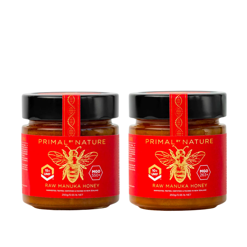 Two jars of Primal Nature Raw Manuka Honey on a white background