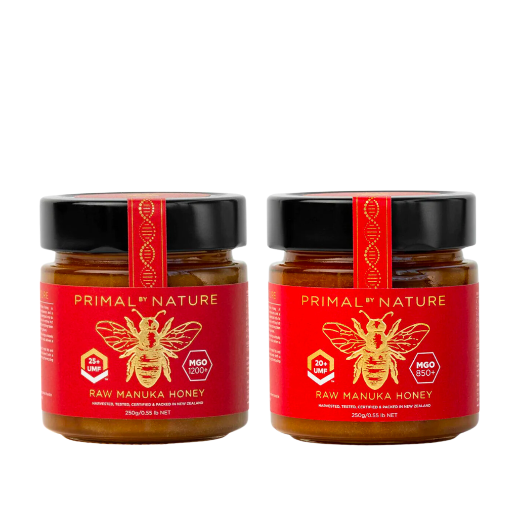 Two jars of Primal Nature Raw Manuka Honey on a white background