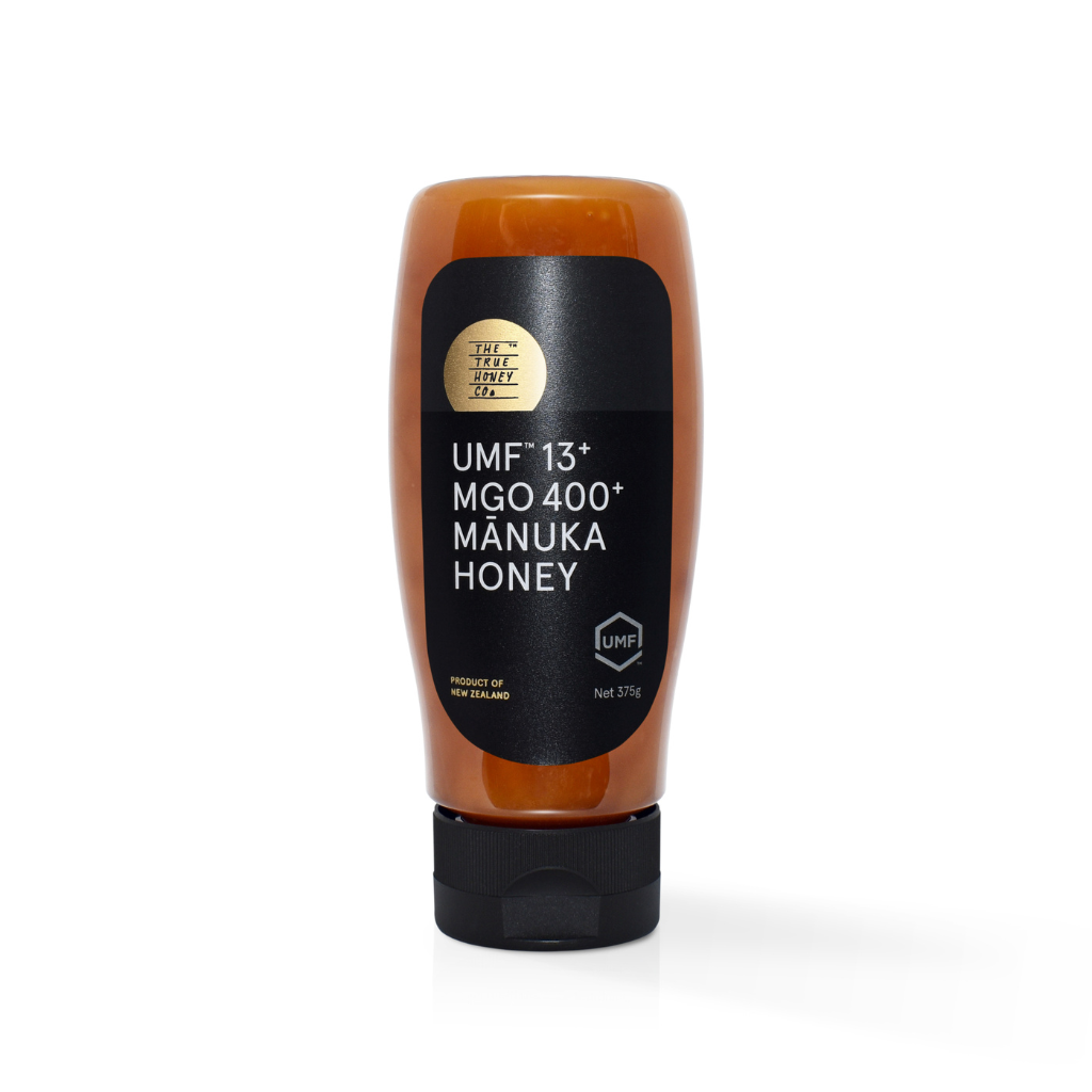 Manuka honey bottle with black label on a white background