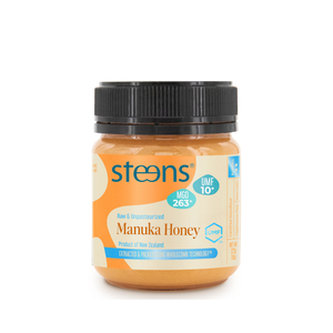 A jar of Steens Manuka Honey on a plain white background. The jar contains golden honey and has a black ribbed screw cap with a cream and blue label.