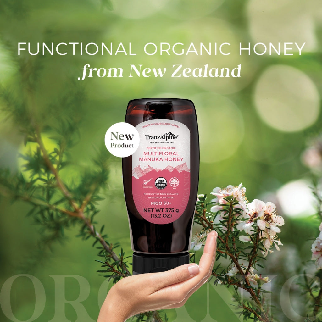 TranzAlpine Organic Multifloral Manuka Honey Squeezy being held in a women's hand