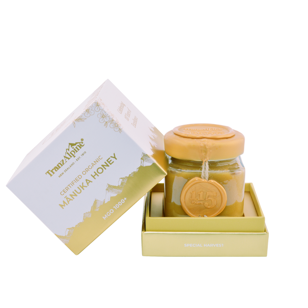 Jar of Manuka Honey with a box on a white background