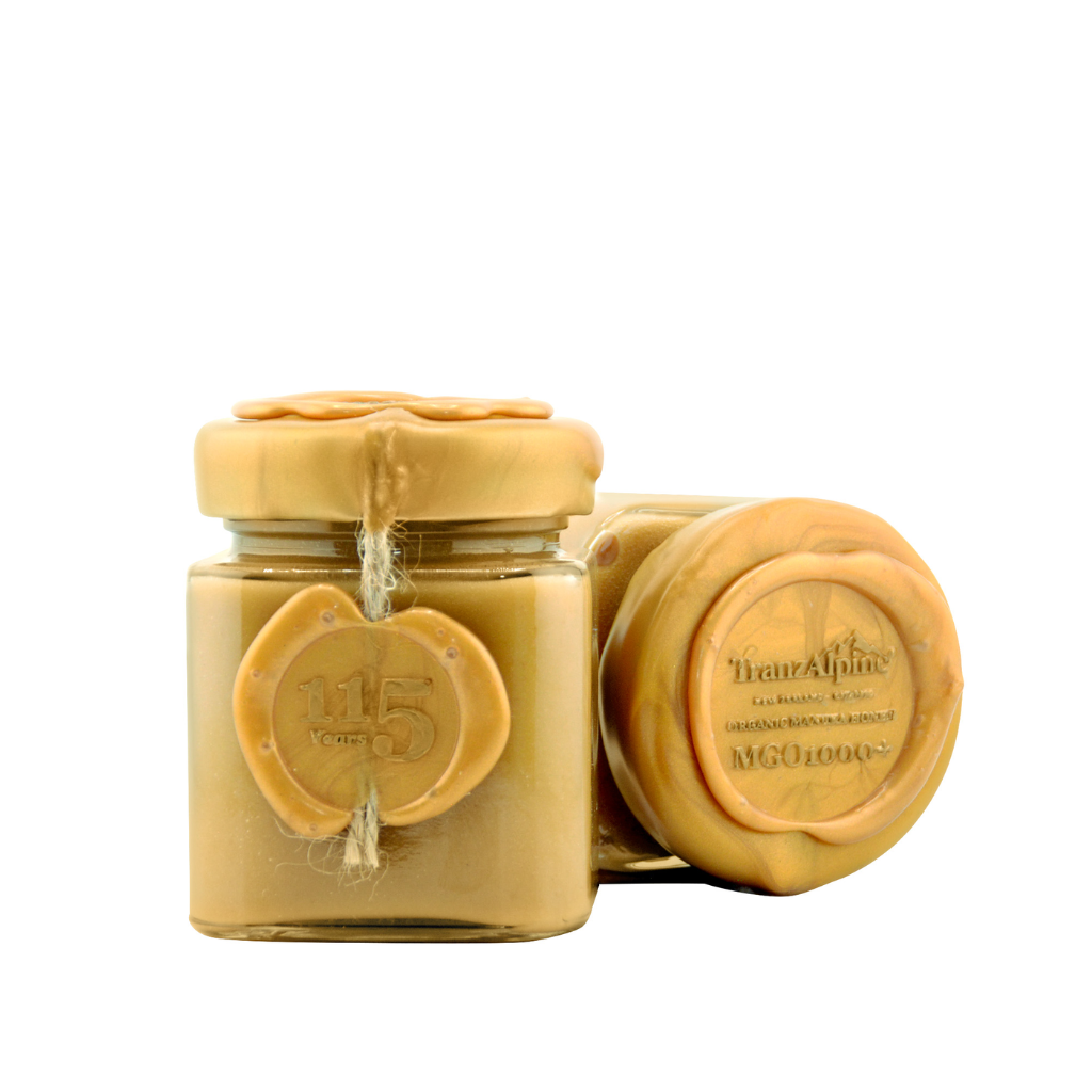 Jar of honey with a yellow lid on a white background