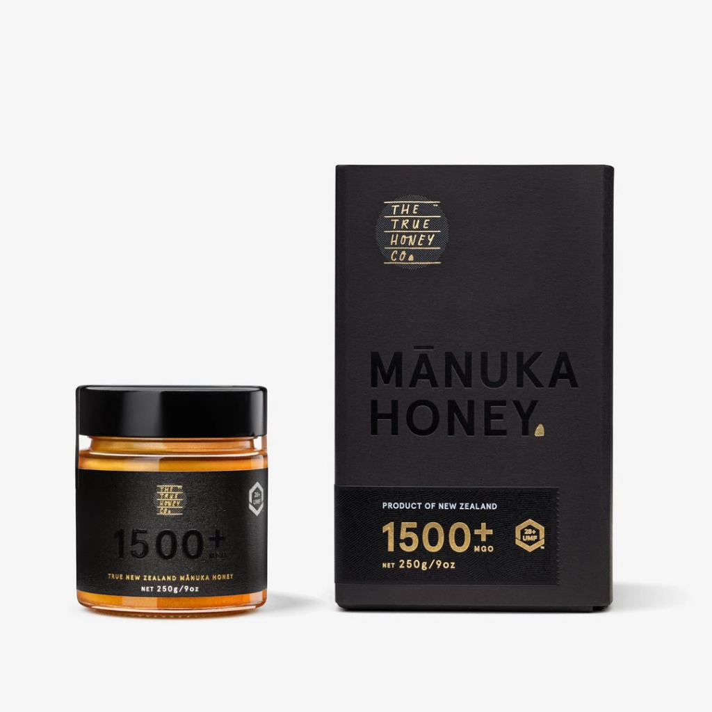 A jar of Manuka honey with its packaging box, displaying the MGO 1500+ and UMF 28+ labels.